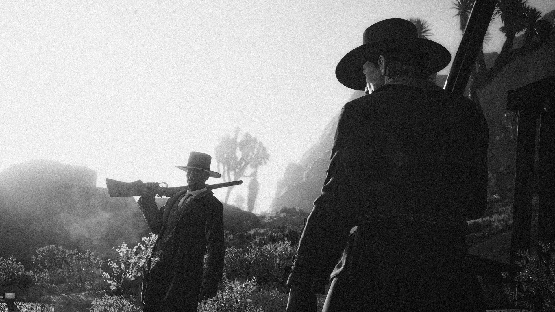 Two men with long guns facing each other among Joshua trees in hazy black and white, the nearer one seen from behind.